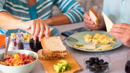 Couple sitting at the table having brunch at home.